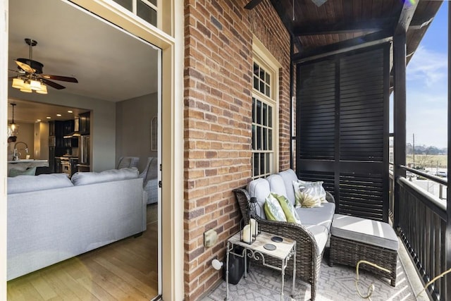 balcony featuring an outdoor living space and a ceiling fan