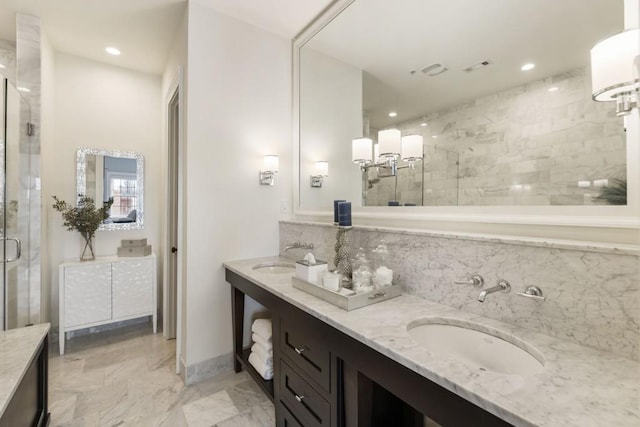 bathroom with double vanity, recessed lighting, a stall shower, and a sink