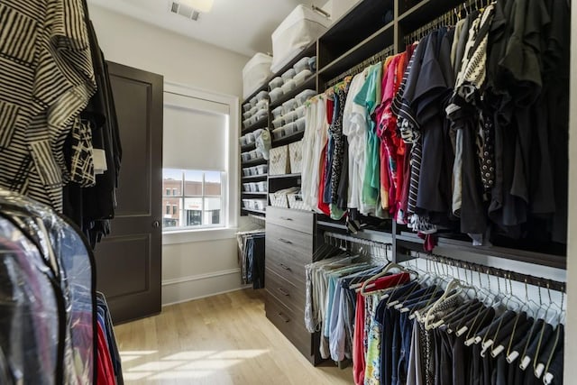 walk in closet with wood finished floors and visible vents