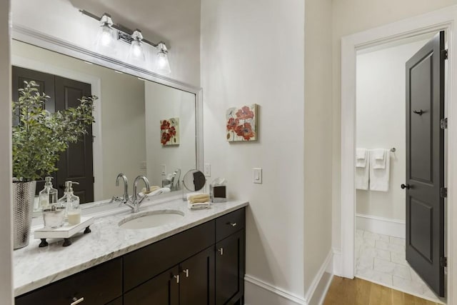 bathroom with vanity and baseboards