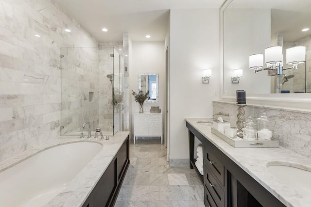 full bath featuring marble finish floor, a stall shower, recessed lighting, double vanity, and a bath