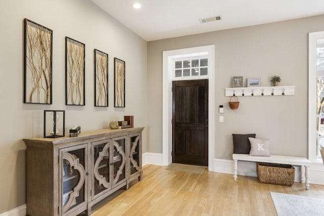 foyer entrance featuring recessed lighting, baseboards, visible vents, and light wood-type flooring