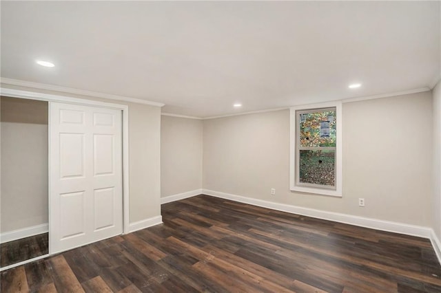 unfurnished bedroom with baseboards, dark wood-style flooring, and ornamental molding