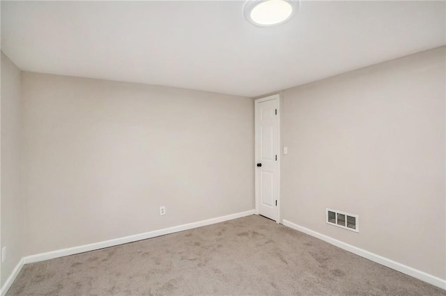 carpeted spare room with baseboards and visible vents