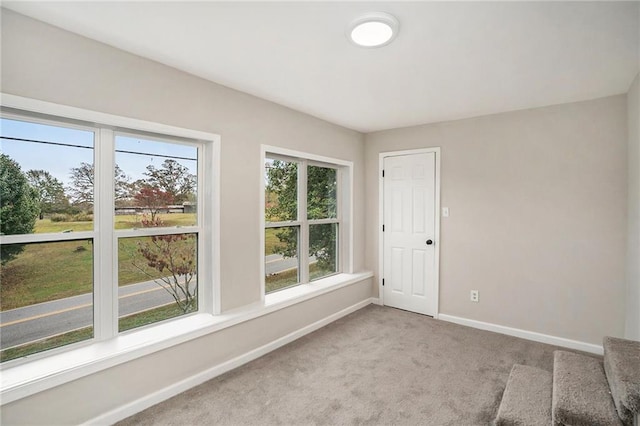 empty room with carpet and baseboards