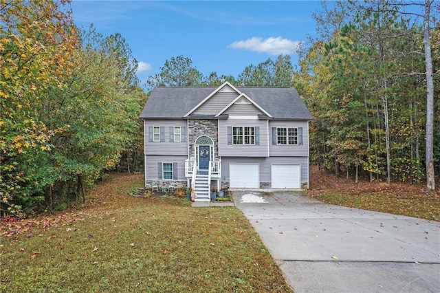 raised ranch featuring a front yard and a garage