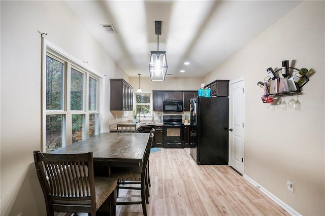 dining room with light hardwood / wood-style flooring and sink