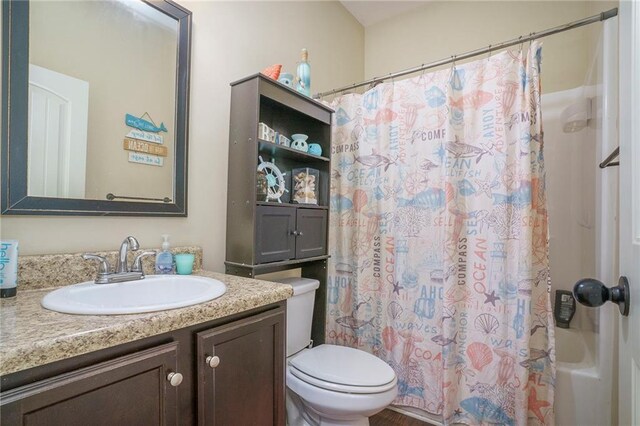 full bathroom featuring vanity, toilet, and shower / tub combo