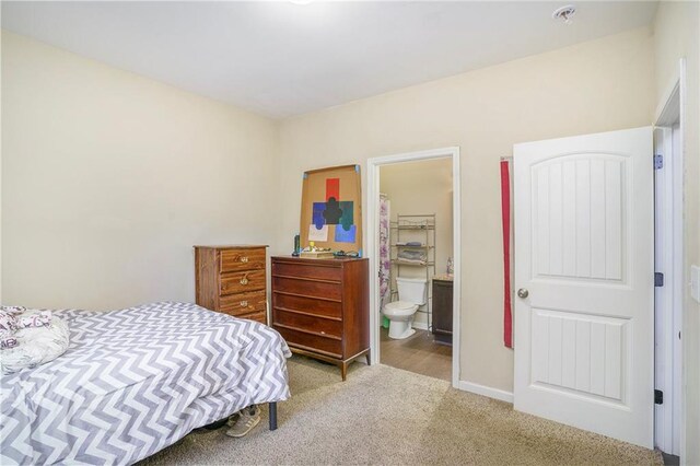 carpeted bedroom featuring ensuite bathroom, a closet, and a spacious closet