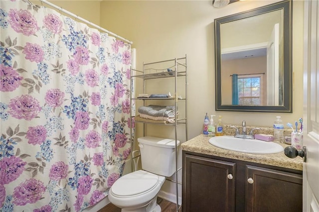 bathroom with a shower with curtain, wood-type flooring, vanity, and toilet