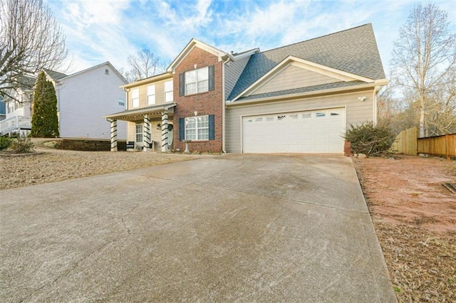 view of front facade with brick siding, roof with shingles, concrete driveway, fence, and a garage