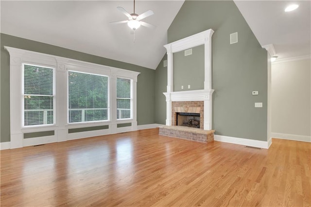 26 Trillium Ln, Acworth, GA 30101 - unfurnished living room featuring lofted ceiling, a ceiling fan, a brick fireplace, light wood-style floors, and baseboards