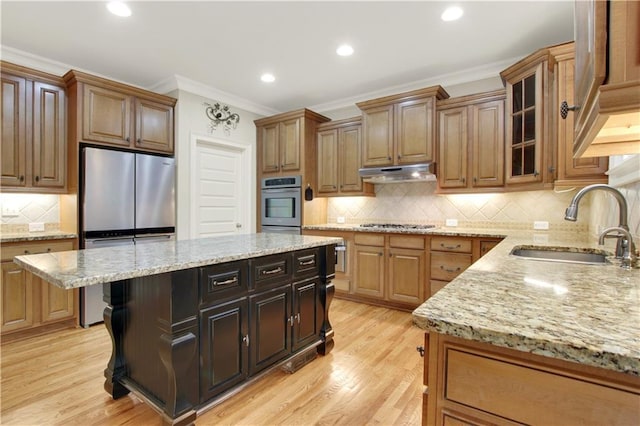 26 Trillium Ln, Acworth, GA 30101 - kitchen featuring under cabinet range hood, crown molding, a sink, backsplash, and light stone counters