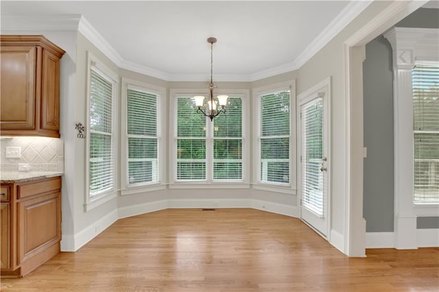 26 Trillium Ln, Acworth, GA 30101 - unfurnished dining area with light wood-type flooring, a chandelier, plenty of natural light, and crown molding
