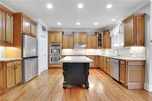 26 Trillium Ln, Acworth, GA 30101 - kitchen with stainless steel appliances, crown molding, a sink, brown cabinetry, and tasteful backsplash