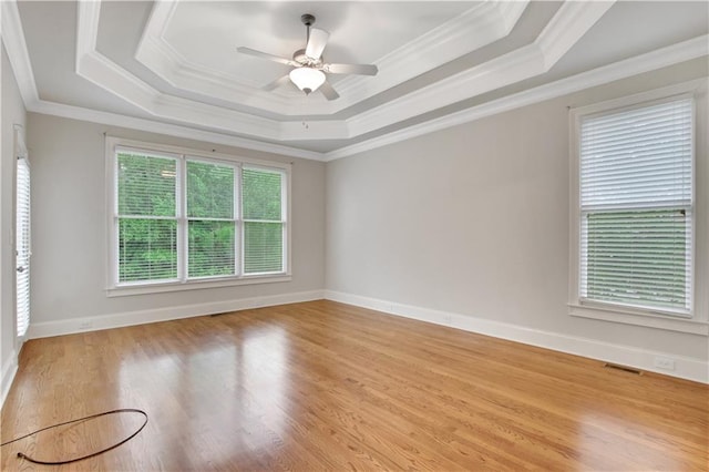 26 Trillium Ln, Acworth, GA 30101 - empty room with a raised ceiling, ornamental molding, light wood finished floors, ceiling fan, and baseboards