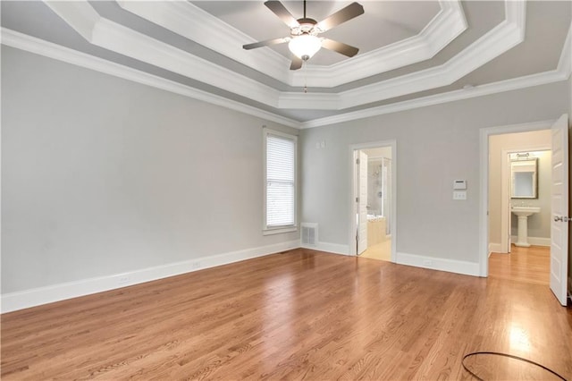 26 Trillium Ln, Acworth, GA 30101 - unfurnished bedroom featuring a tray ceiling, crown molding, light wood-type flooring, ensuite bath, and ceiling fan