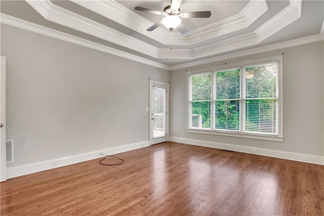 26 Trillium Ln, Acworth, GA 30101 - empty room featuring a raised ceiling, crown molding, wood finished floors, a ceiling fan, and baseboards