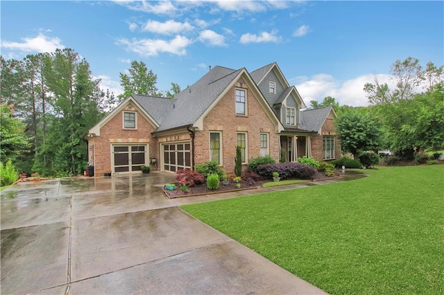 26 Trillium Ln, Acworth, GA 30101 - view of front facade featuring brick siding, a front yard, concrete driveway, an attached garage, and roof with shingles