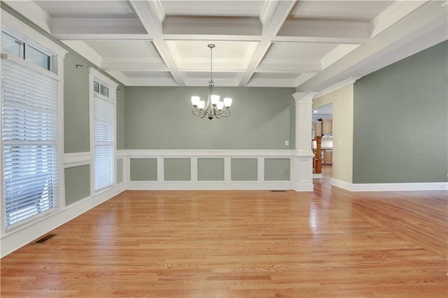 26 Trillium Ln, Acworth, GA 30101 - unfurnished dining area featuring a chandelier, beam ceiling, coffered ceiling, light wood-style floors, and ornate columns
