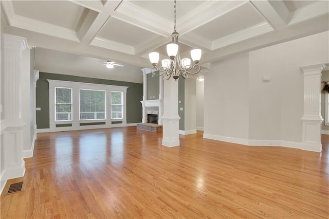 26 Trillium Ln, Acworth, GA 30101 - unfurnished living room featuring a brick fireplace, a ceiling fan, a chandelier, coffered ceiling, and light wood-type flooring