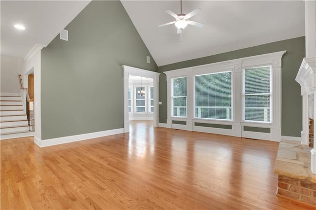 26 Trillium Ln, Acworth, GA 30101 - unfurnished living room featuring a fireplace with raised hearth, ceiling fan, plenty of natural light, high vaulted ceiling, and stairway