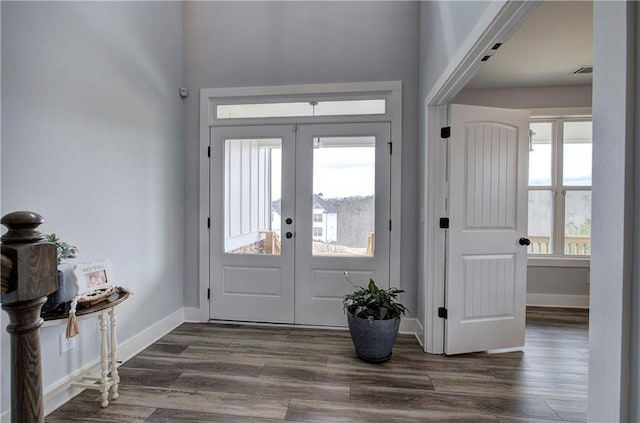 foyer featuring french doors, baseboards, visible vents, and dark wood-style floors