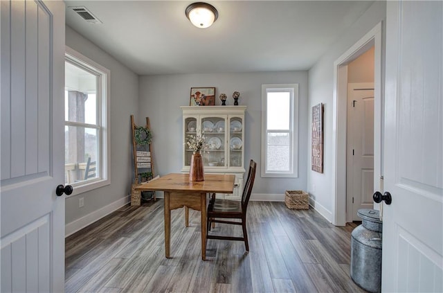 interior space featuring visible vents, baseboards, and wood finished floors