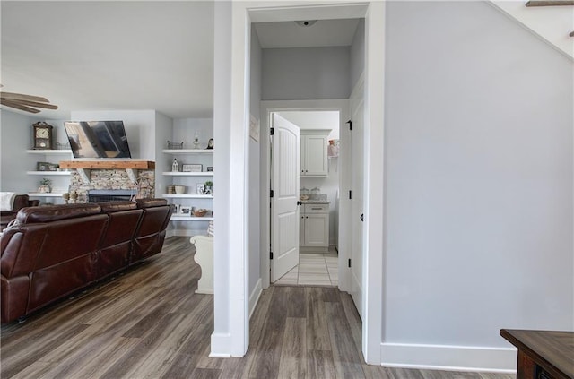 hall featuring baseboards and wood finished floors