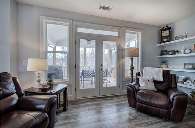 living area with visible vents, plenty of natural light, and french doors