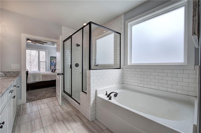 ensuite bathroom featuring vanity, a ceiling fan, ensuite bath, a stall shower, and a bath