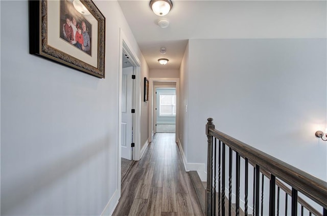 hallway with baseboards and wood finished floors