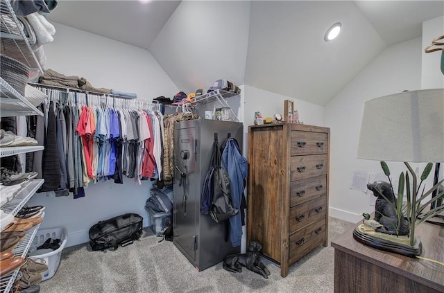 walk in closet with vaulted ceiling and carpet floors