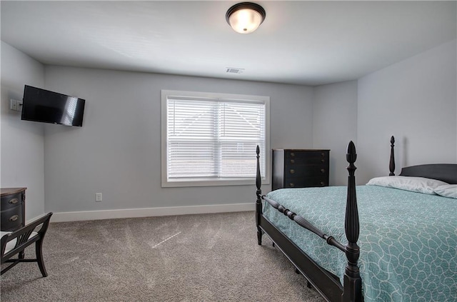 carpeted bedroom with visible vents and baseboards