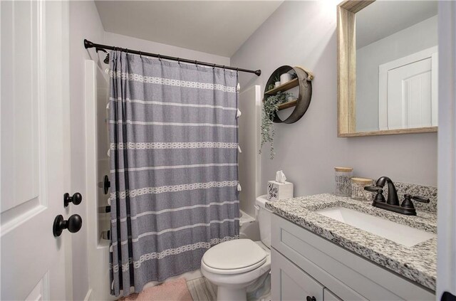 full bath featuring vanity, toilet, and shower / tub combo with curtain