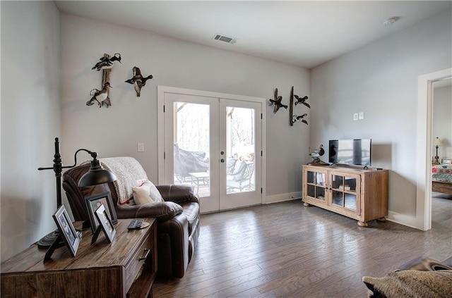 living area with french doors, wood-type flooring, baseboards, and visible vents