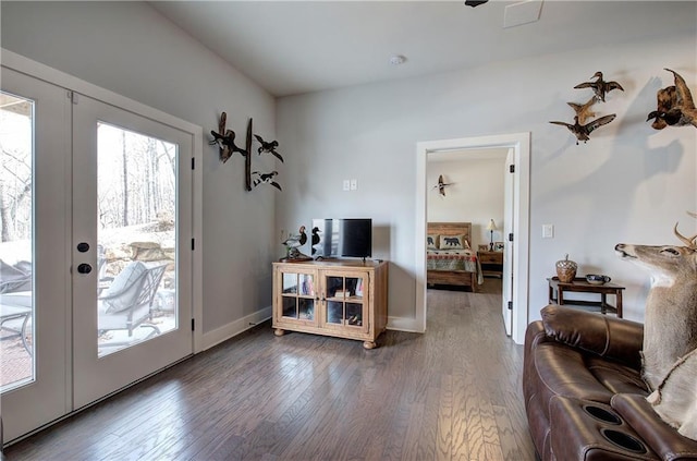 interior space with french doors, baseboards, and wood finished floors