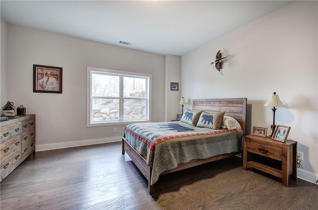 bedroom featuring visible vents, wood finished floors, and baseboards