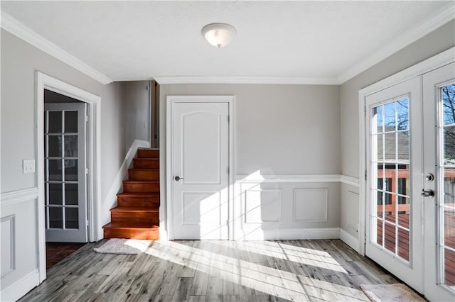 empty room with ornamental molding, french doors, and hardwood / wood-style flooring