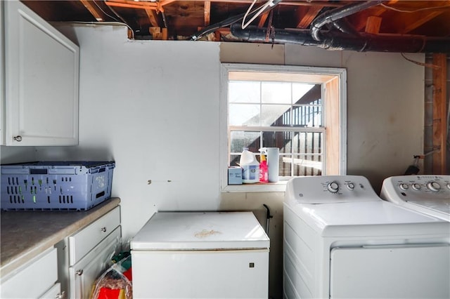 washroom with cabinets and washer and clothes dryer