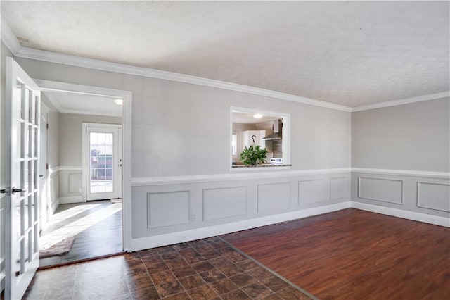 unfurnished room with french doors and crown molding