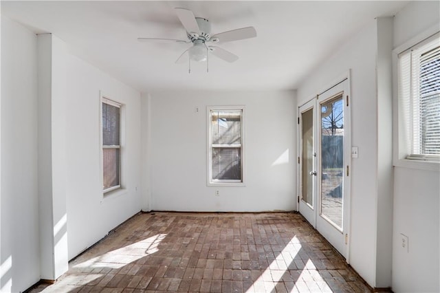 unfurnished room featuring ceiling fan and french doors