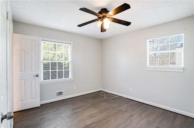 unfurnished room with ceiling fan and dark hardwood / wood-style flooring