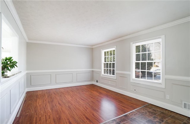 empty room featuring crown molding and dark hardwood / wood-style floors