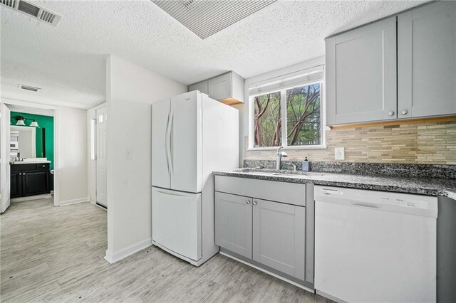 66 Fair Haven Way SE, Smyrna, GA 30080 - half bath with a textured ceiling, wood finished floors, baseboards, vanity, and toilet