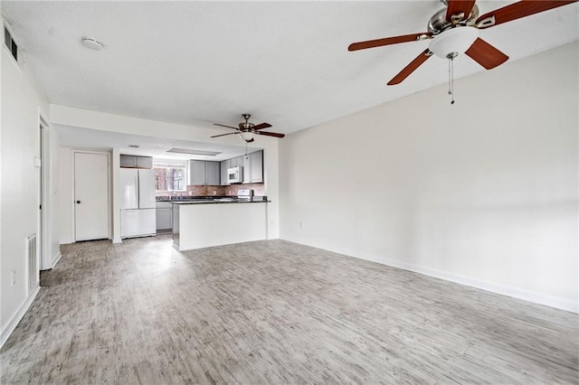 66 Fair Haven Way SE, Smyrna, GA 30080 - unfurnished living room featuring a fireplace with flush hearth, a textured ceiling, baseboards, and wood finished floors
