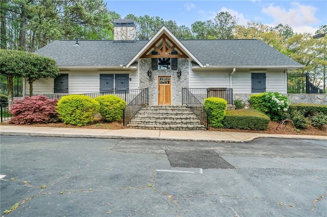 66 Fair Haven Way SE, Smyrna, GA 30080 - view of front facade with roof with shingles, stone siding, and a chimney