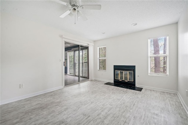 66 Fair Haven Way SE, Smyrna, GA 30080 - unfurnished living room featuring baseboards, a fireplace with flush hearth, a textured ceiling, and wood finished floors