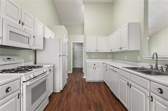 kitchen featuring sink, dark wood-type flooring, white cabinets, and white appliances