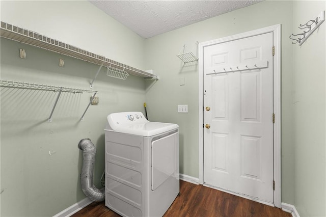 clothes washing area with dark hardwood / wood-style floors, washer / dryer, and a textured ceiling